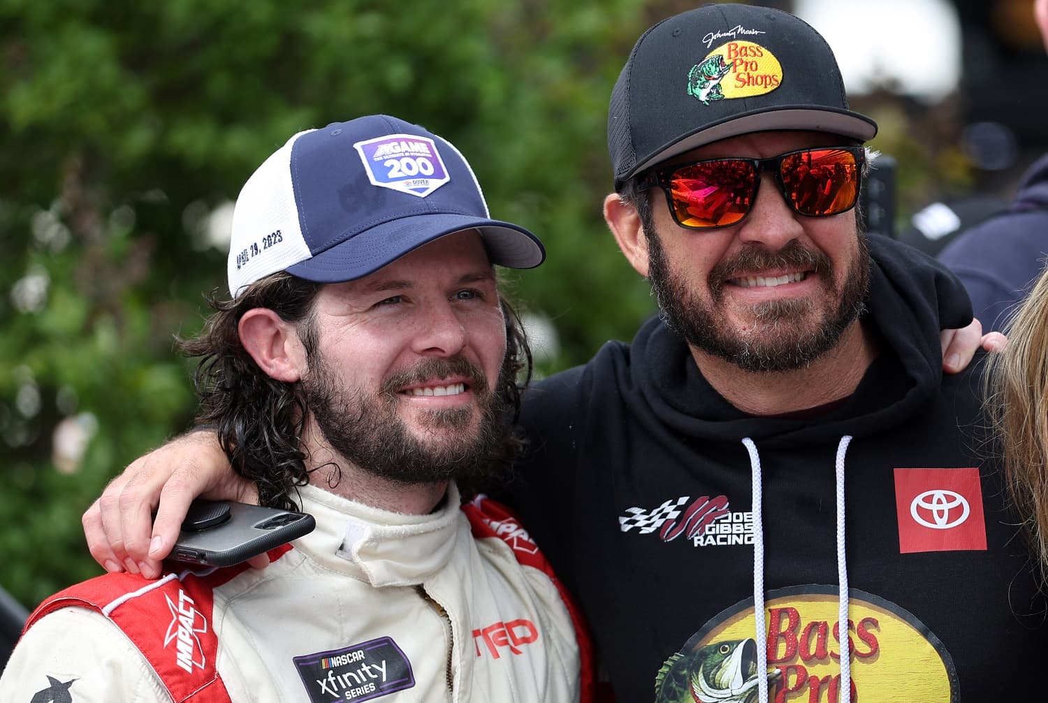 Ryan Truex celebrates with NASCAR Series Cup driver Martin Truex Jr. after winning  the Xfinity Series A-GAME 200 at Dover International Speedway on April 29, 2023. | James Gilbert/Getty Images