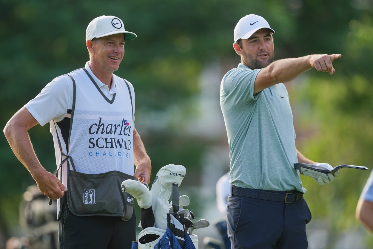 Scottie Scheffler and caddie Ted Scott share a laugh on the fairway of hole #10 before an approach shot during Round One of the Charles Schwab Challenge at Colonial Country Club on May 25, 2023 in Ft. Worth, Texas