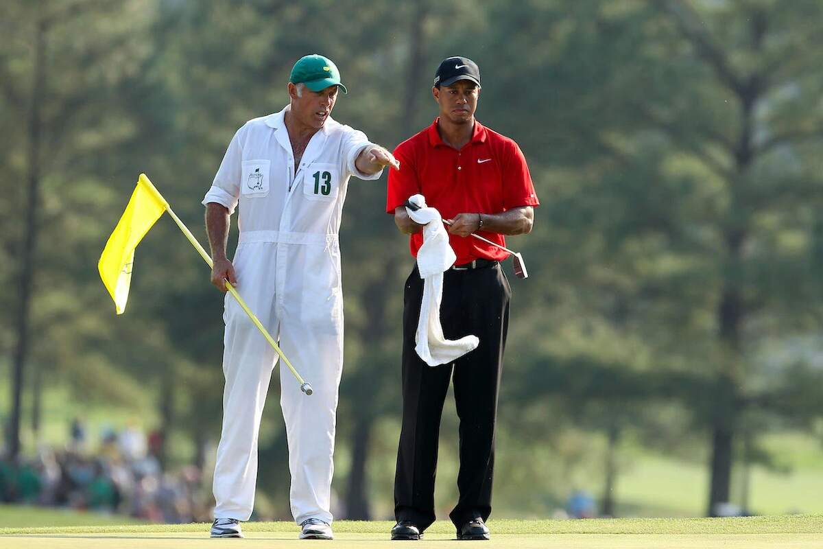 Golfers Tiger Woods and Steve Williams talk strategy during the final round of the 2011 Masters Tournament