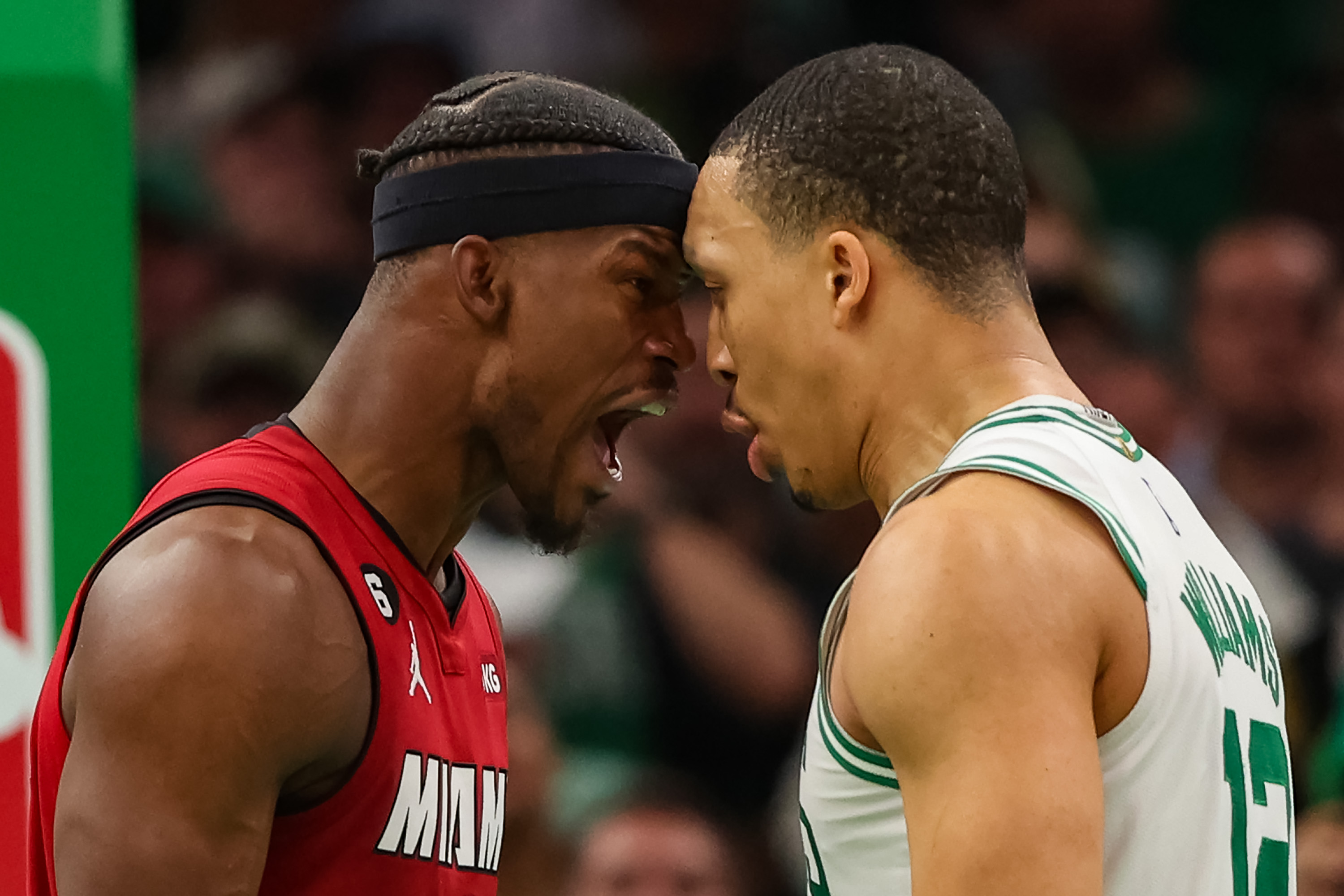 Jimmy Butler of the Miami Heat exchanges words with Grant Williams of the Boston Celtics.