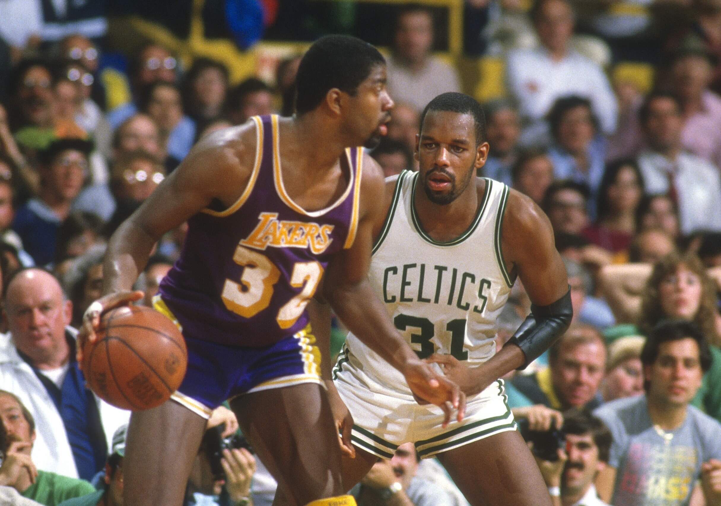 Cedric Maxwell of the Boston Celtics defends Magic Johnson of the Los Angeles Lakers.