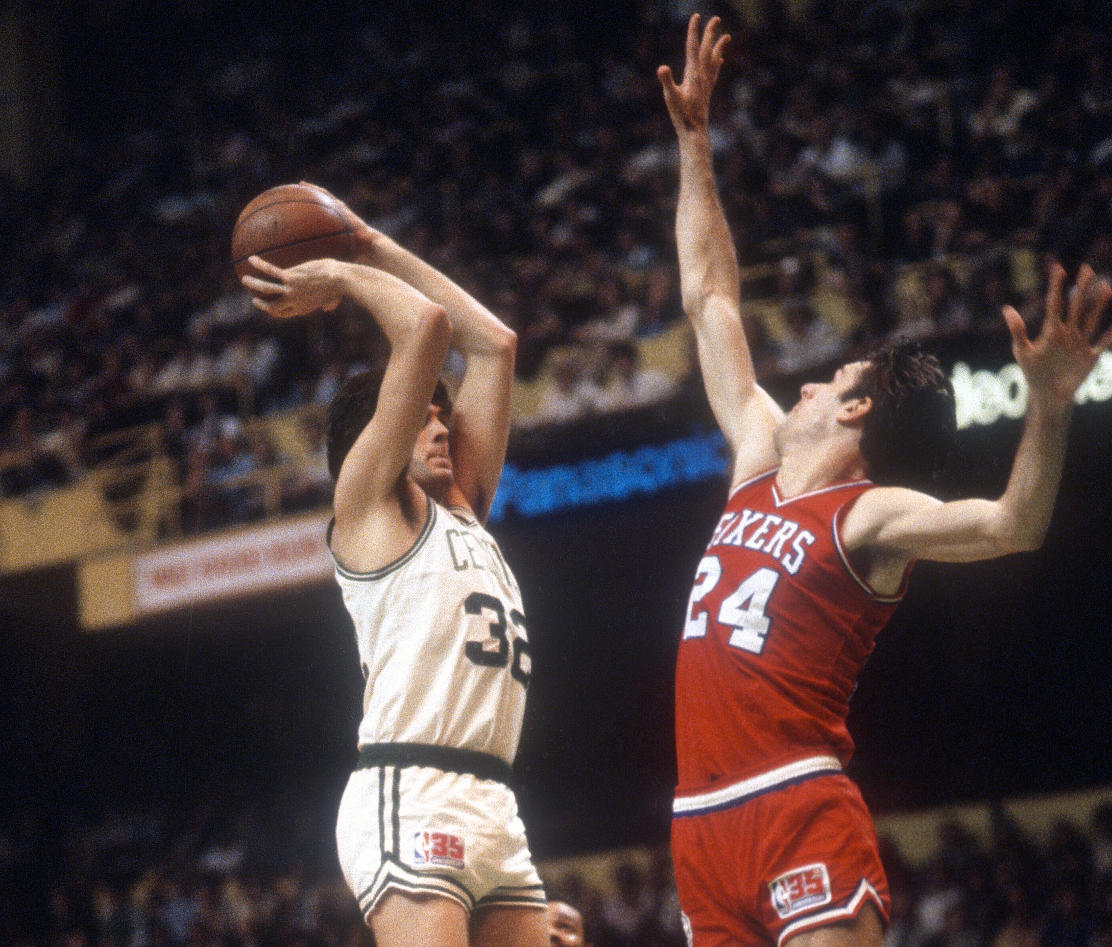 Kevin McHale of the Boston Celtics shoots over Bobby Jones of the Philadelphia 76ers.