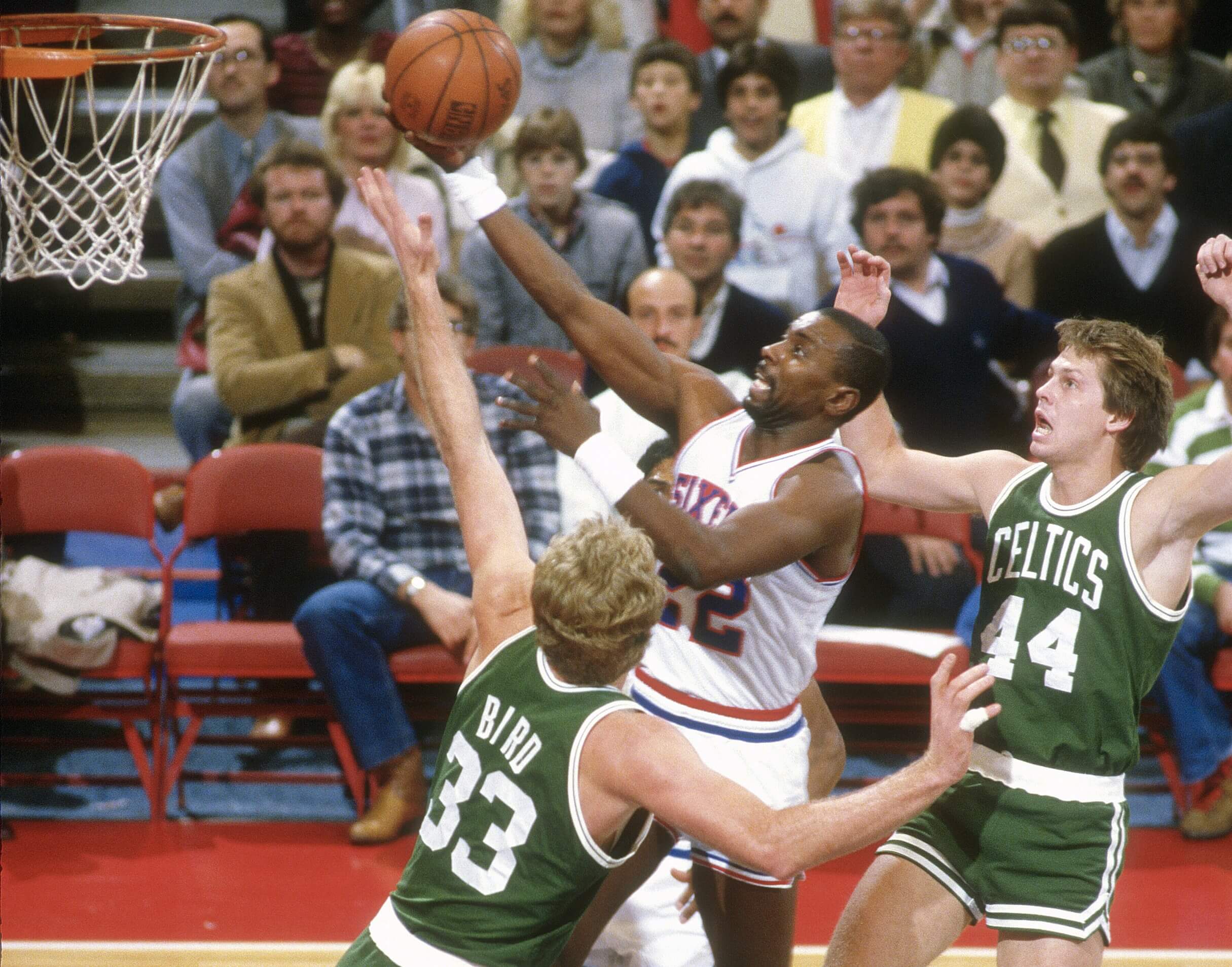 Andrew Toney of the Philadelphia 76ers goes in for a layup over Larry Bird of the Boston Celtics.