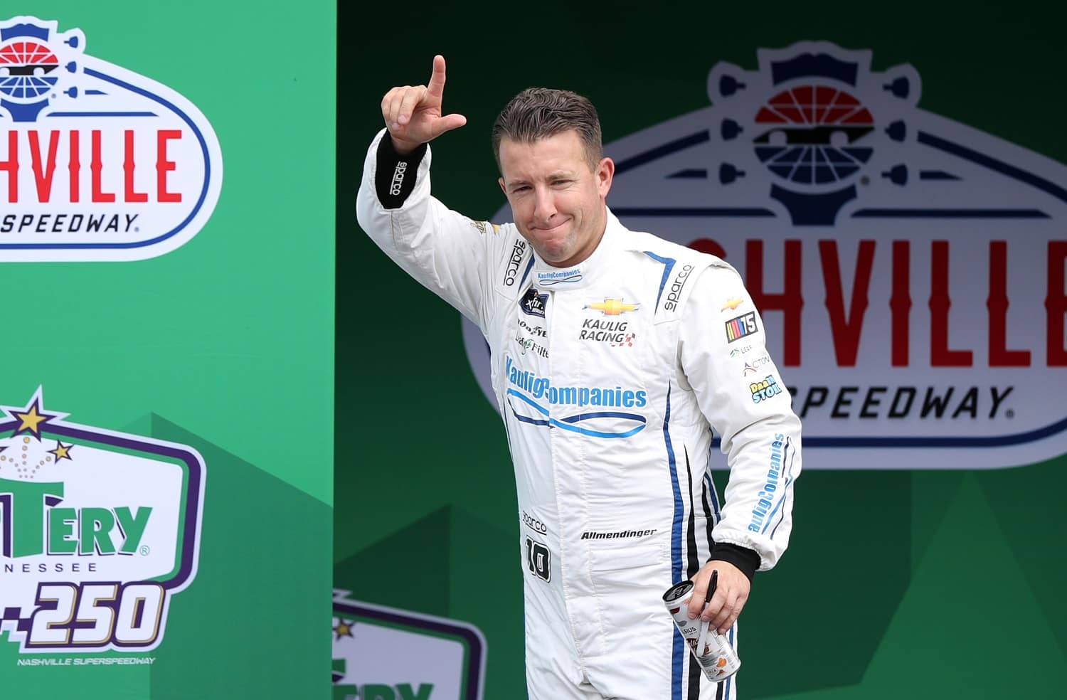 AJ Allmendinger waves to fans as he walks onstage during driver intros for the NASCAR Xfinity Series Tennessee Lottery 250 at Nashville Superspeedway on June 24, 2023.