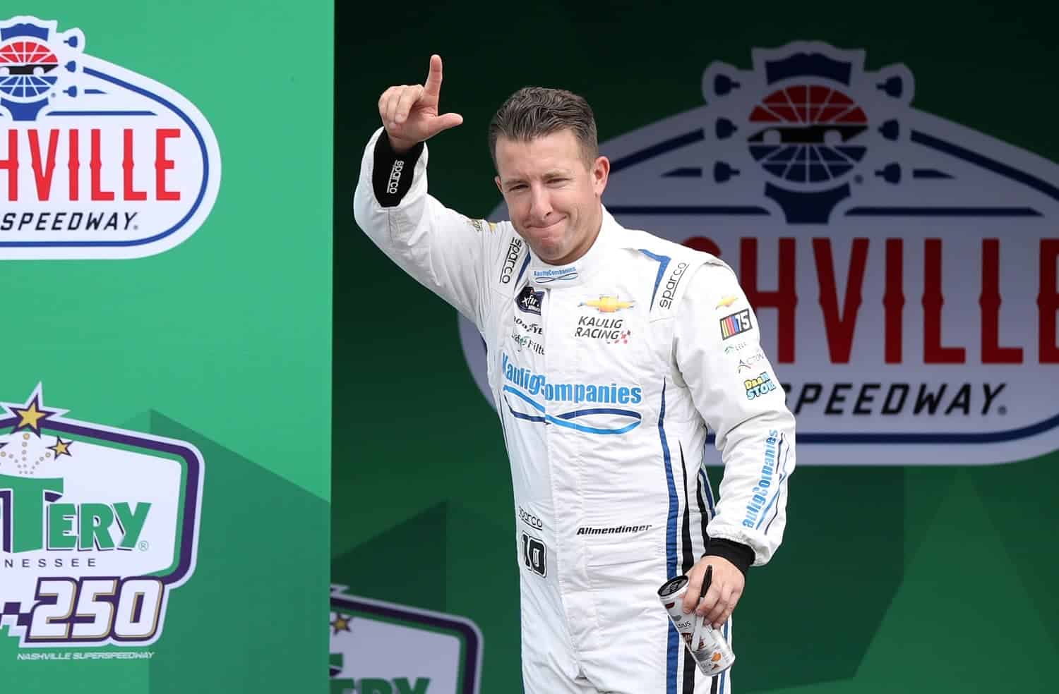 AJ Allmendinger waves to fans as he walks onstage during driver intros for the NASCAR Xfinity Series Tennessee Lottery 250 at Nashville Superspeedway on June 24, 2023.