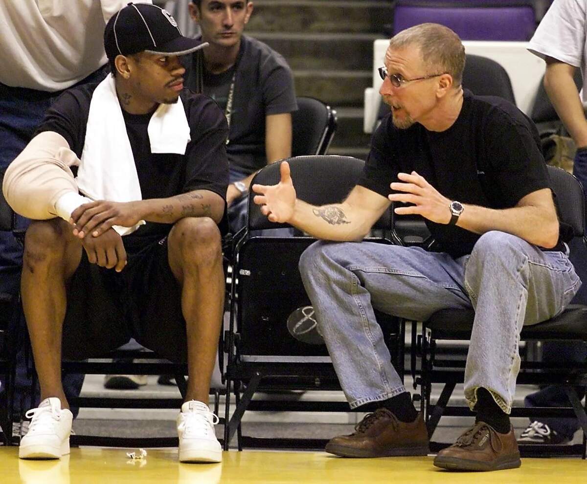 NBA star Allen Iverson and Pat Croce talk on the sideline of a basketball game