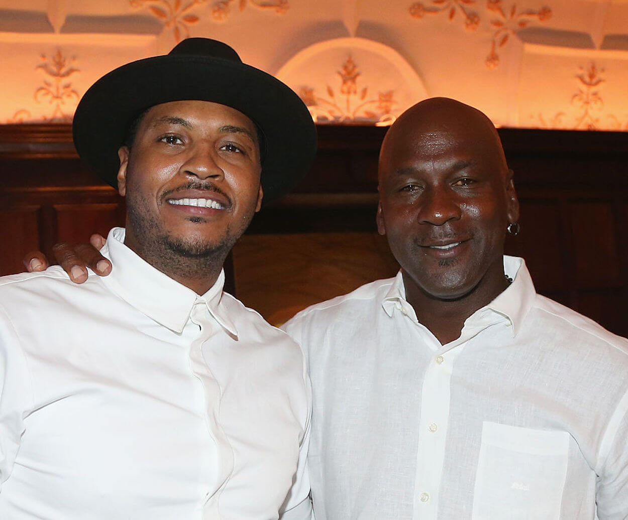 Carmelo Anthony (L) and Michael Jordan (R) pose at a 2016 event.
