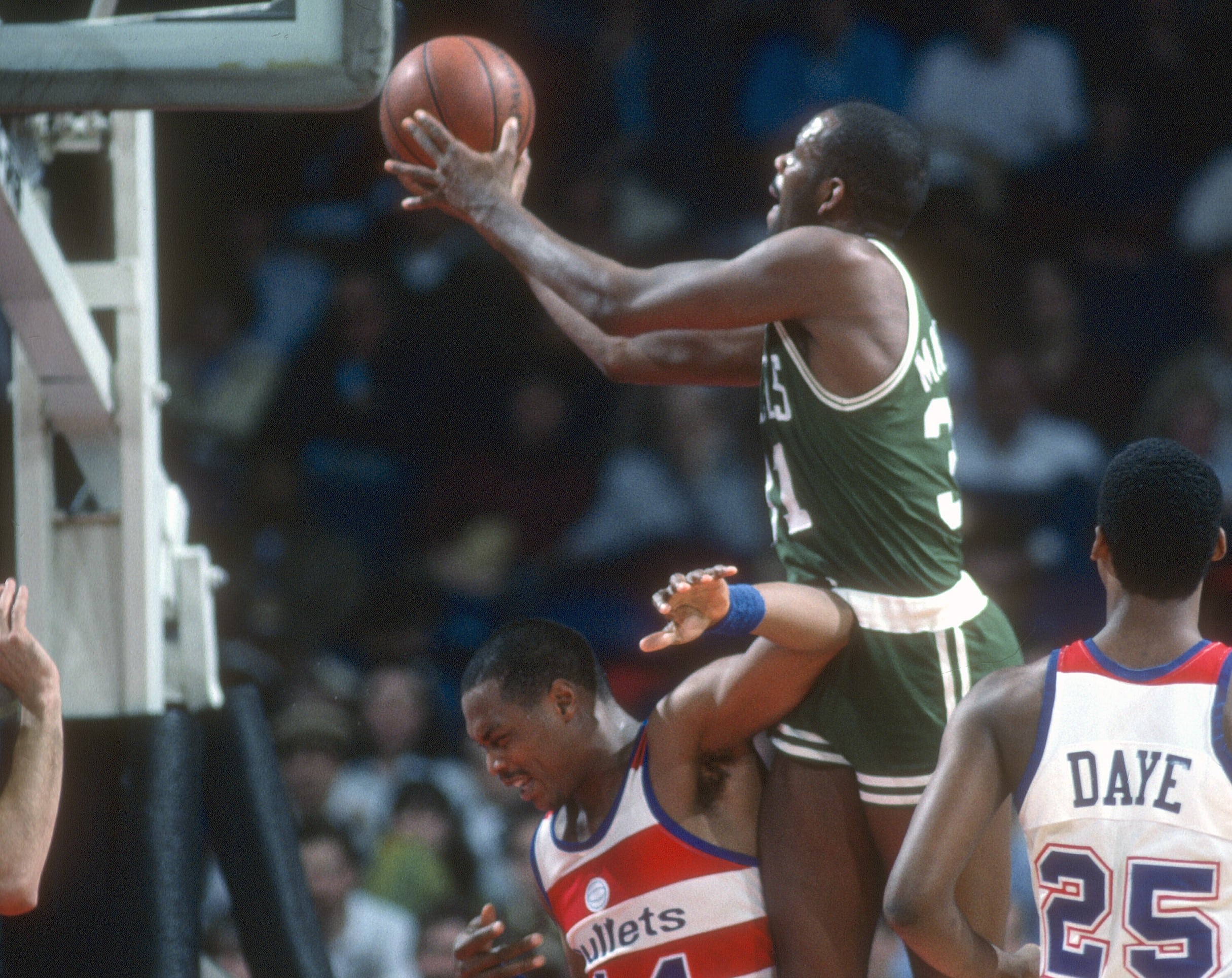 Cedric Maxwell of the Boston Celtics shoots over Rick Mahorn of the Washington Bullets.