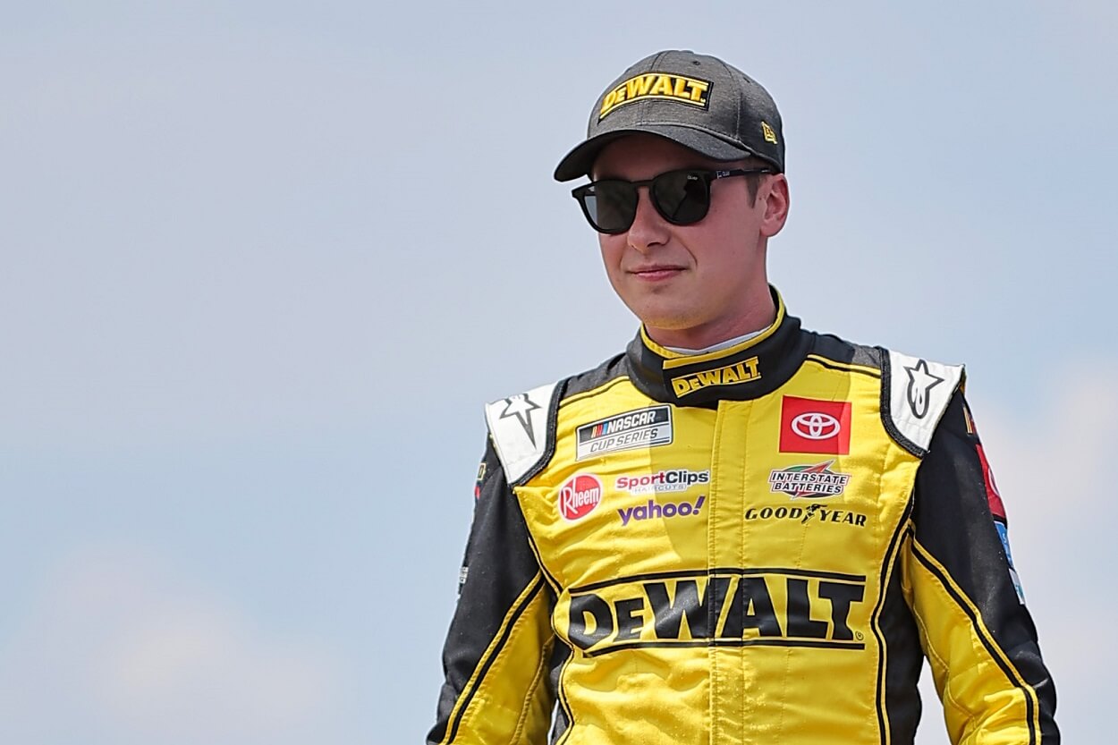 Christopher Bell, driver of the #20 DeWalt Construction Technology Toyota, walks onstage during driver intros prior to the NASCAR Cup Series Enjoy Illinois 300 at WWT Raceway on June 04, 2023, in Madison, Illinois