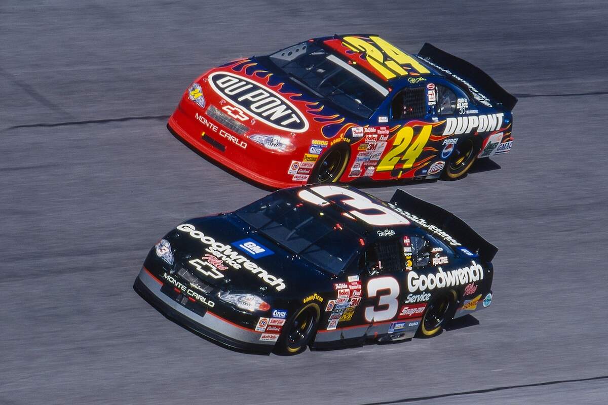 NASCAR drivers Dale Earnhardt and Jeff Gordon race around the track