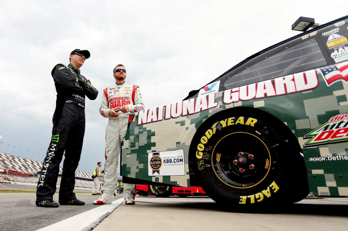 Drivers Kyle Busch (L), driver of the #18 Interstate Batteries Toyota, talks to Dale Earnhardt Jr., driver of the #88 National Guard Chevrolet, on the grid during qualifying for the 2014 NASCAR Sprint Cup Series