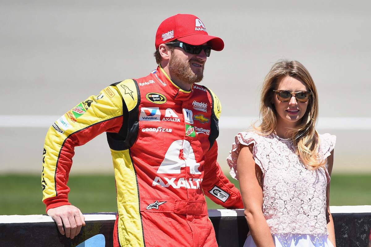 NASCAR driver Dale Earnhardt Jr. stands with his wife off the track