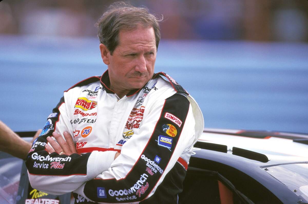 NASCAR driver Dale Earnhardt leans against his car in 1997