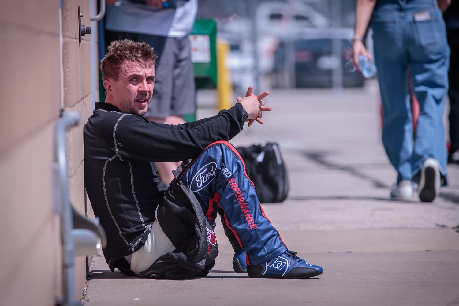 Driver and actor Frankie Muniz sits in the pits following the ARCA Menards Series Dawn 150 at Kansas Speedway in Kansas City, Kansas.