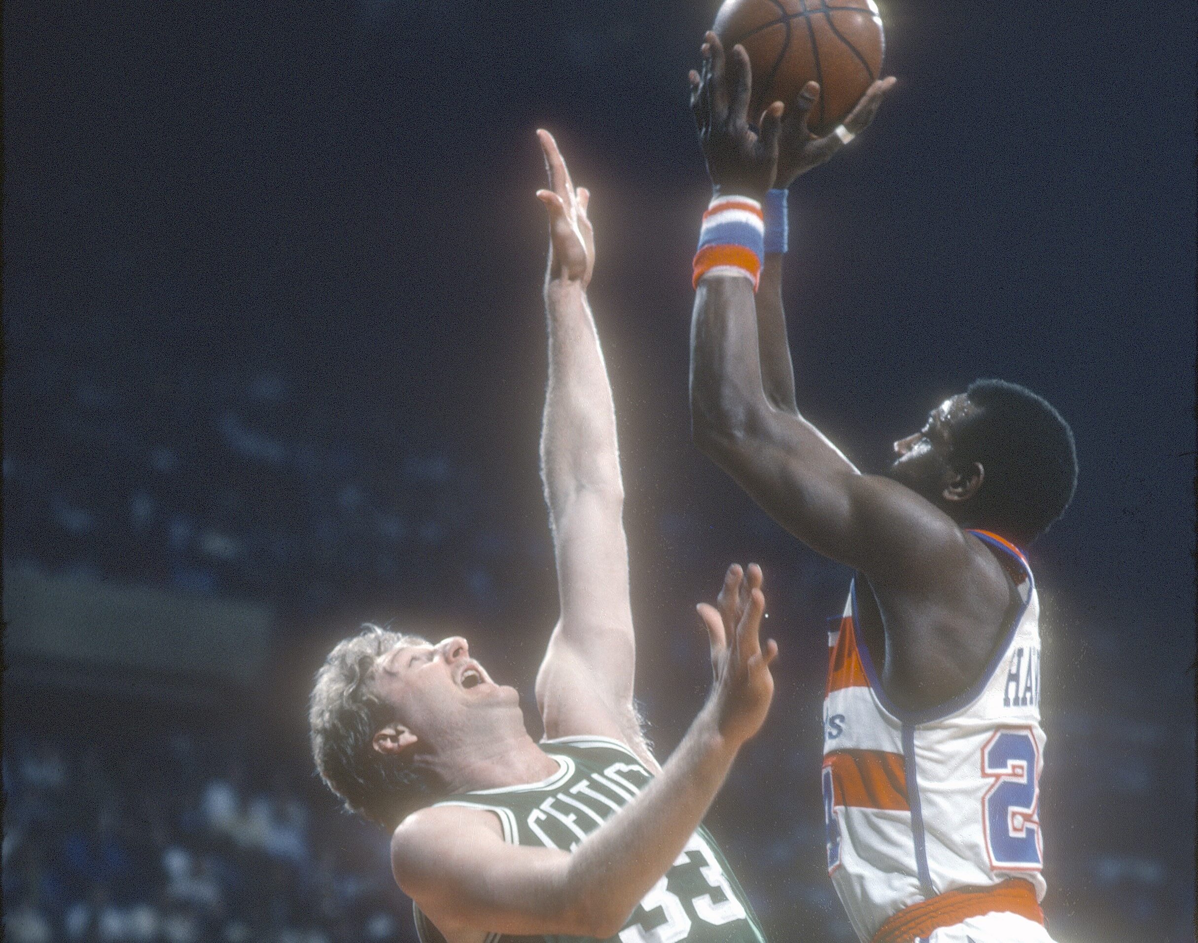 Spencer Haywood of the Washington Bullets shoots over Larry Bird of the Boston Celtics.