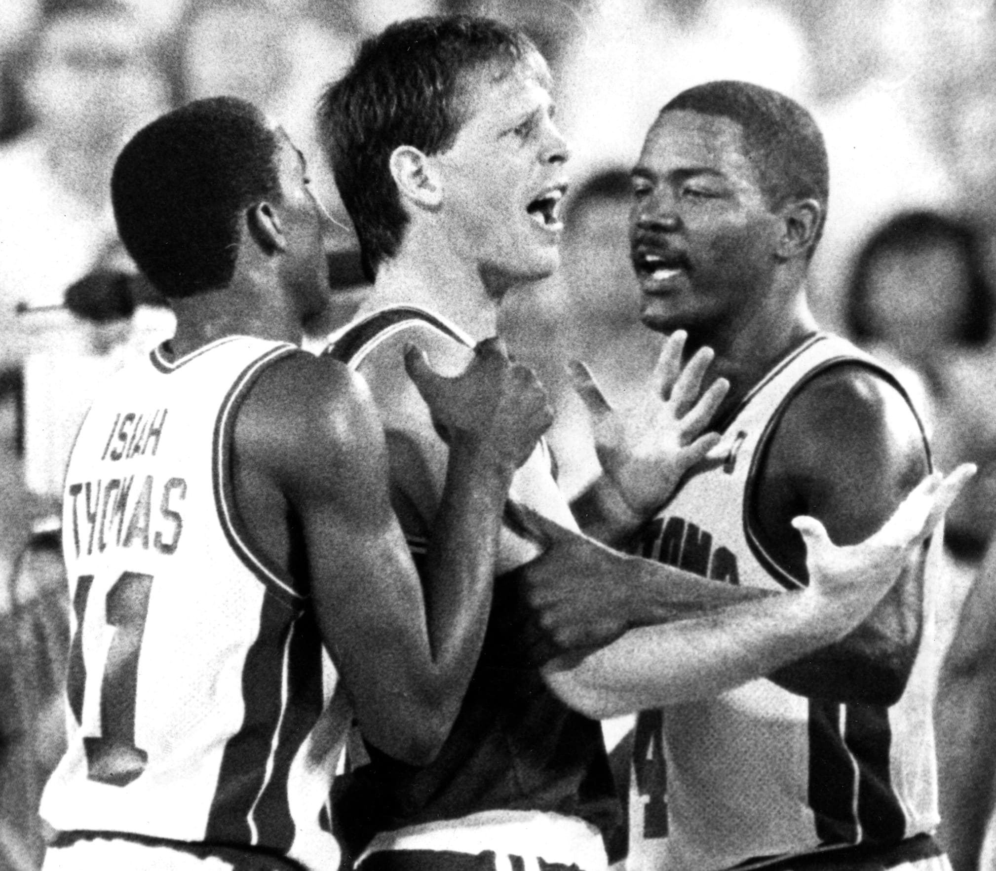 Boston Celtics guard Danny Ainge is restrained by Detroit's Isiah Thomas, left, and Joe Dumars.