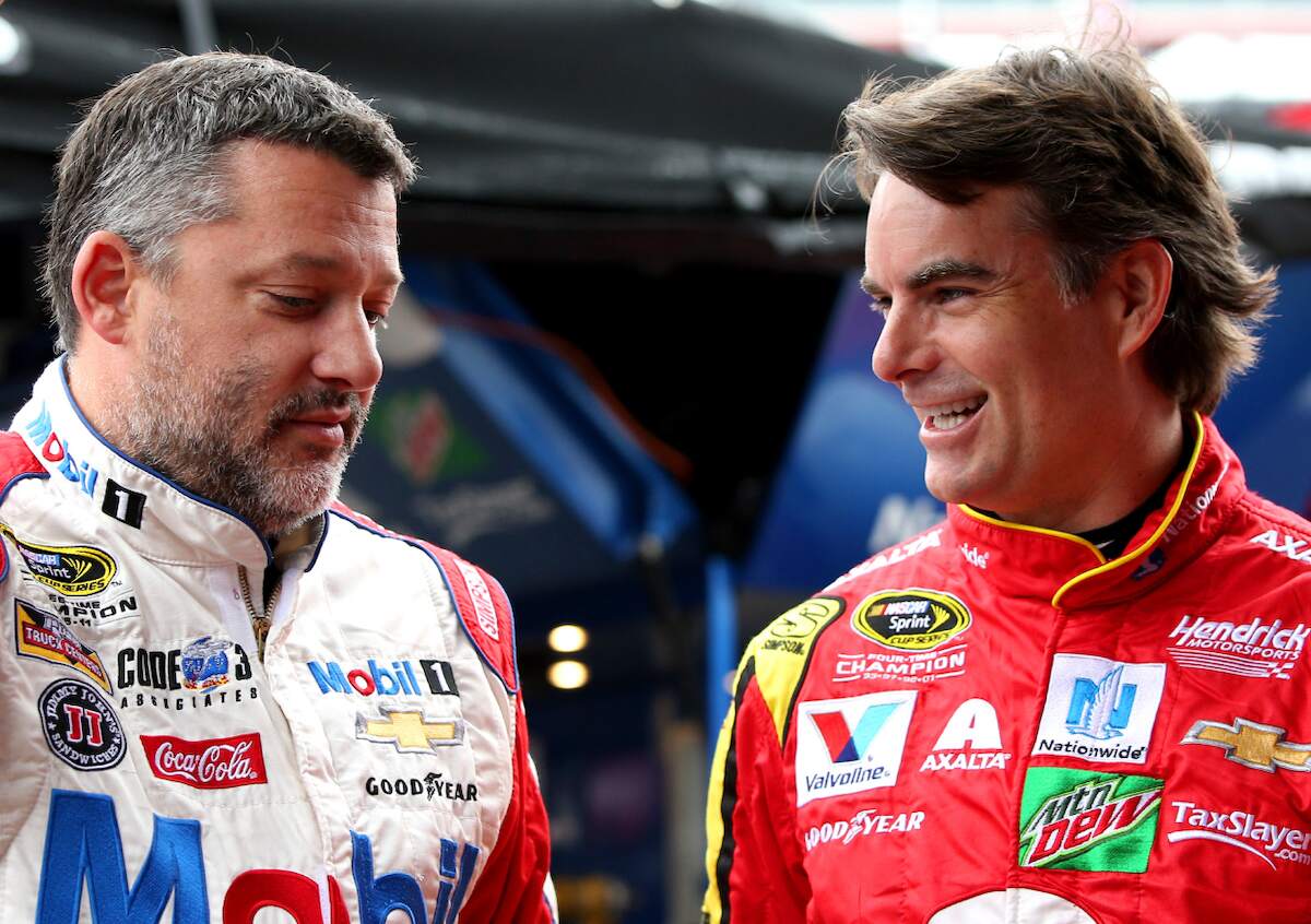 Drivers Tony Stewart, driver of the #14 Haas Automation Chevrolet, talks to Jeff Gordon, driver of the #88 Axalta Chevrolet, in the garage area during practice for the 2016 NASCAR Sprint Cup Series