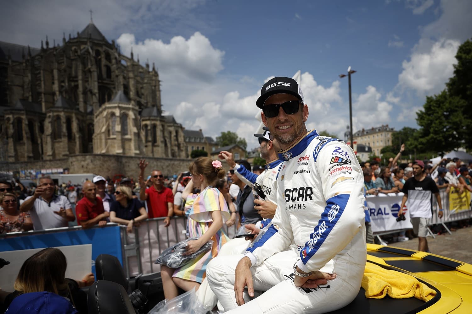 Jimmie Johnson, Mike Rockenfeller and Jenson Button of the NASCAR Next Gen Chevrolet ZL1 team attend the drivers parade ahead of the 100th anniversary of the 24 Hours of Le Mans at the Circuit de la Sarthe on June 9, 2023.