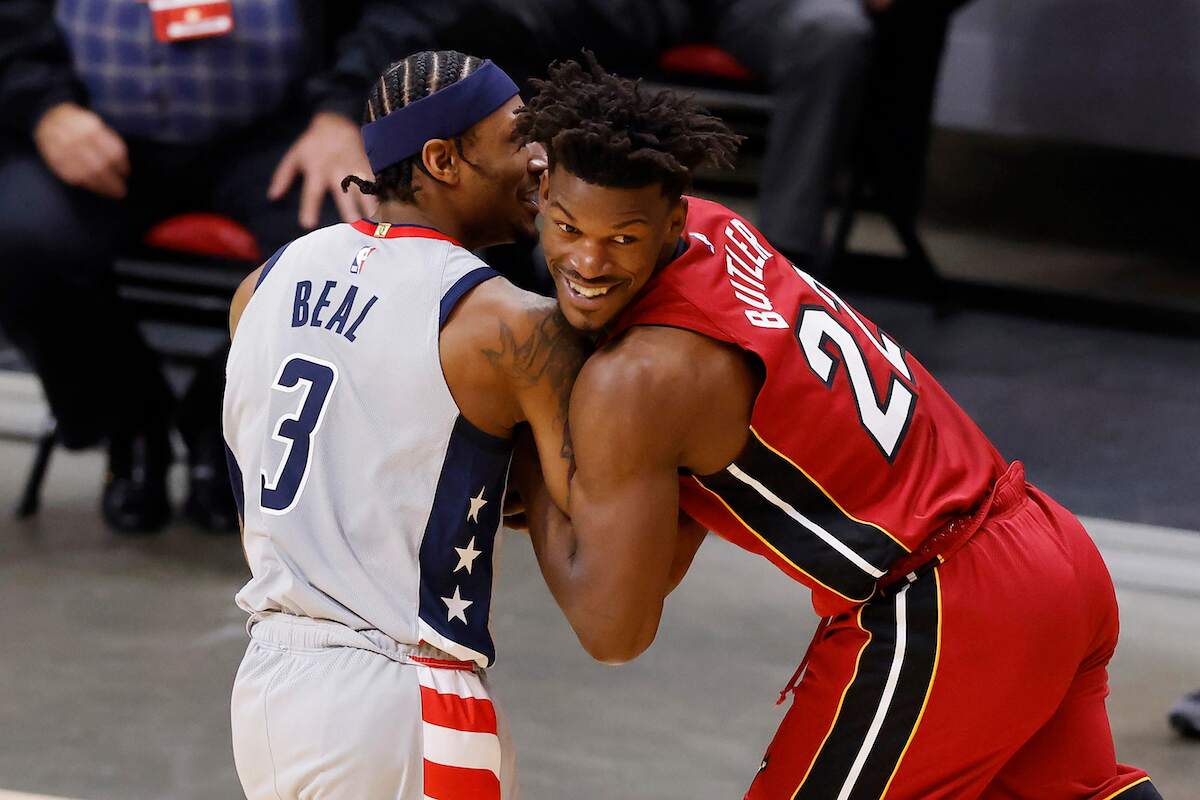The Miami Heat's Jimmy Butler laughs as he guards Bradley Beal