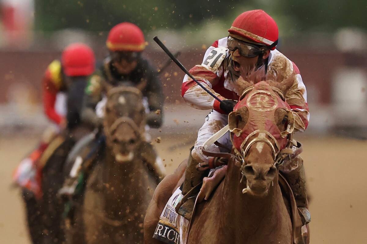 Jockey Sonny Leon cheers as Rich Strike wins the 148th running of the Kentucky Derby at Churchill Downs on May 07, 2022