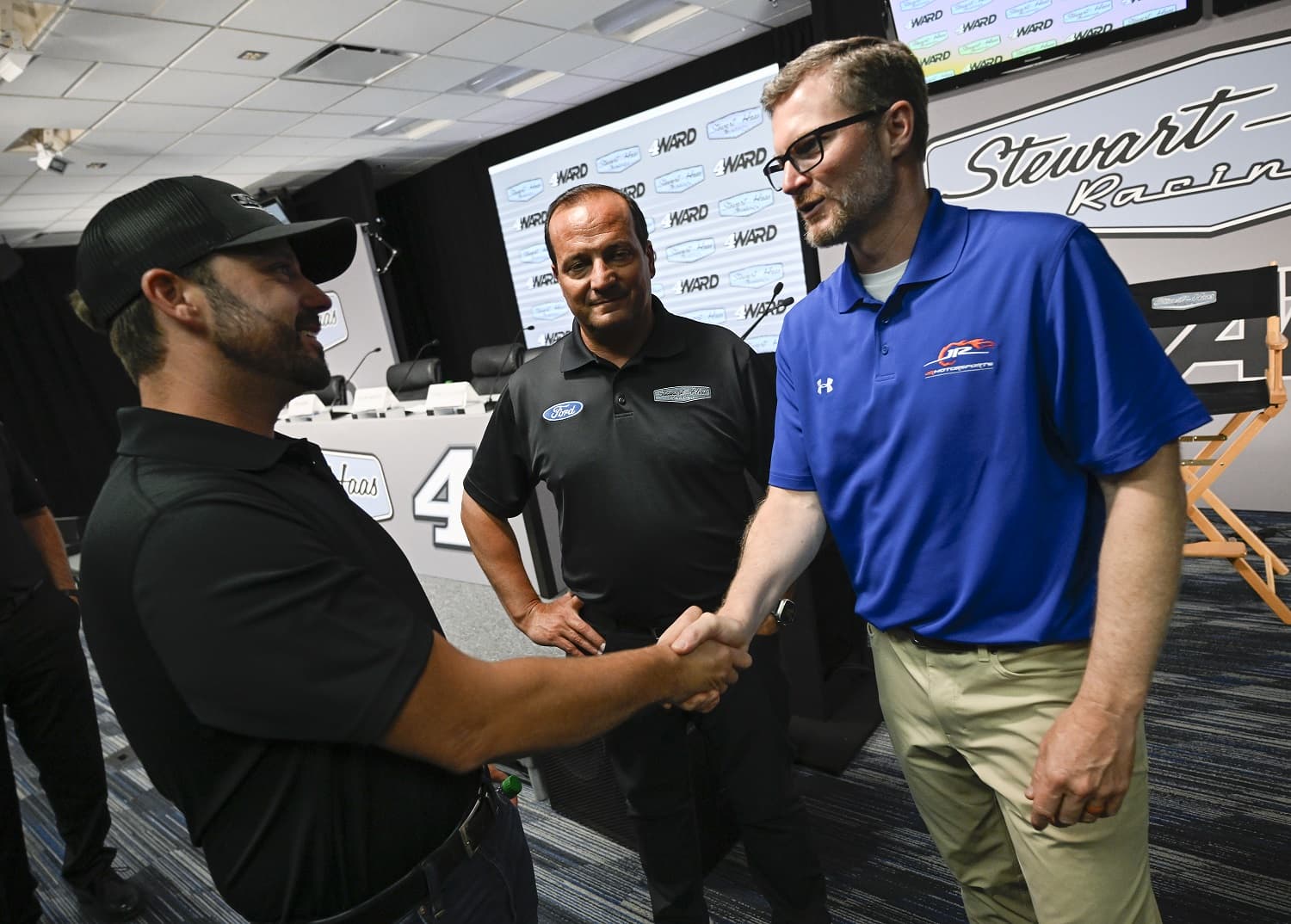 Josh Berry, left, greets Dale Earnhardt Jr. after being introduced as the new driver of the No. 4 Stewart-Hass Racing Ford at Charlotte Motor Speedway on June 21, 2023.