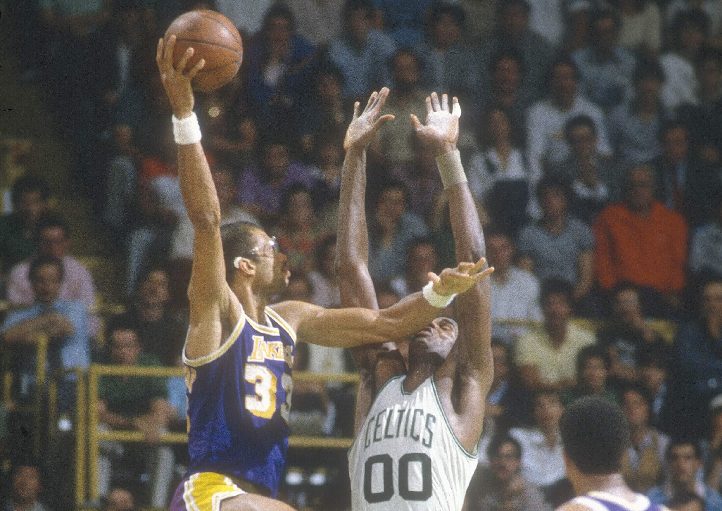 Kareem Abdul-Jabbar of the Los Angeles Lakers shoots over Robert Parish of the Boston Celtics.