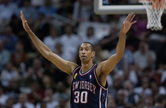 Nets player Kerry Kittles holds up his arms during a game