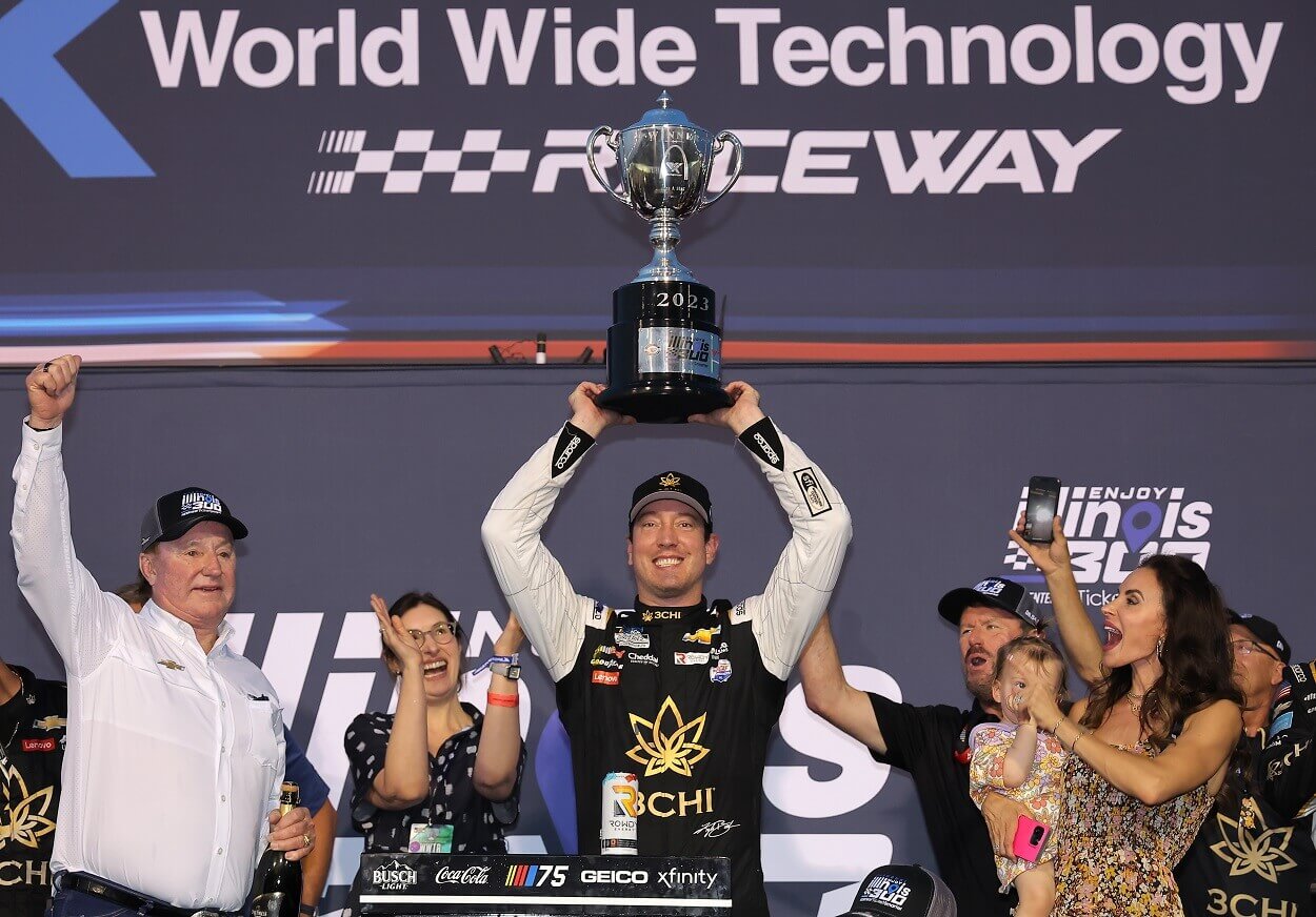 Kyle Busch, driver of the #8 3CHI Chevrolet, celebrates with RCR team owner and NASCAR Hall of Famer, Richard Childress and wife, Samantha Busch in victory lane after winning the NASCAR Cup Series Enjoy Illinois 300 at WWT Raceway on June 04, 2023 in Madison, Illinois