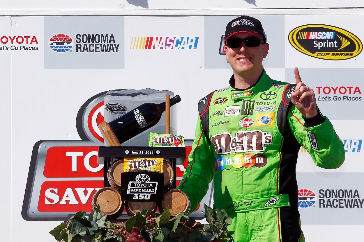 Kyle Busch, driver of the #18 M&M's Crispy Toyota, poses with the trophy after winning the NASCAR Sprint Cup Series Toyota/Save Mart 350 at Sonoma Raceway on June 28, 2015