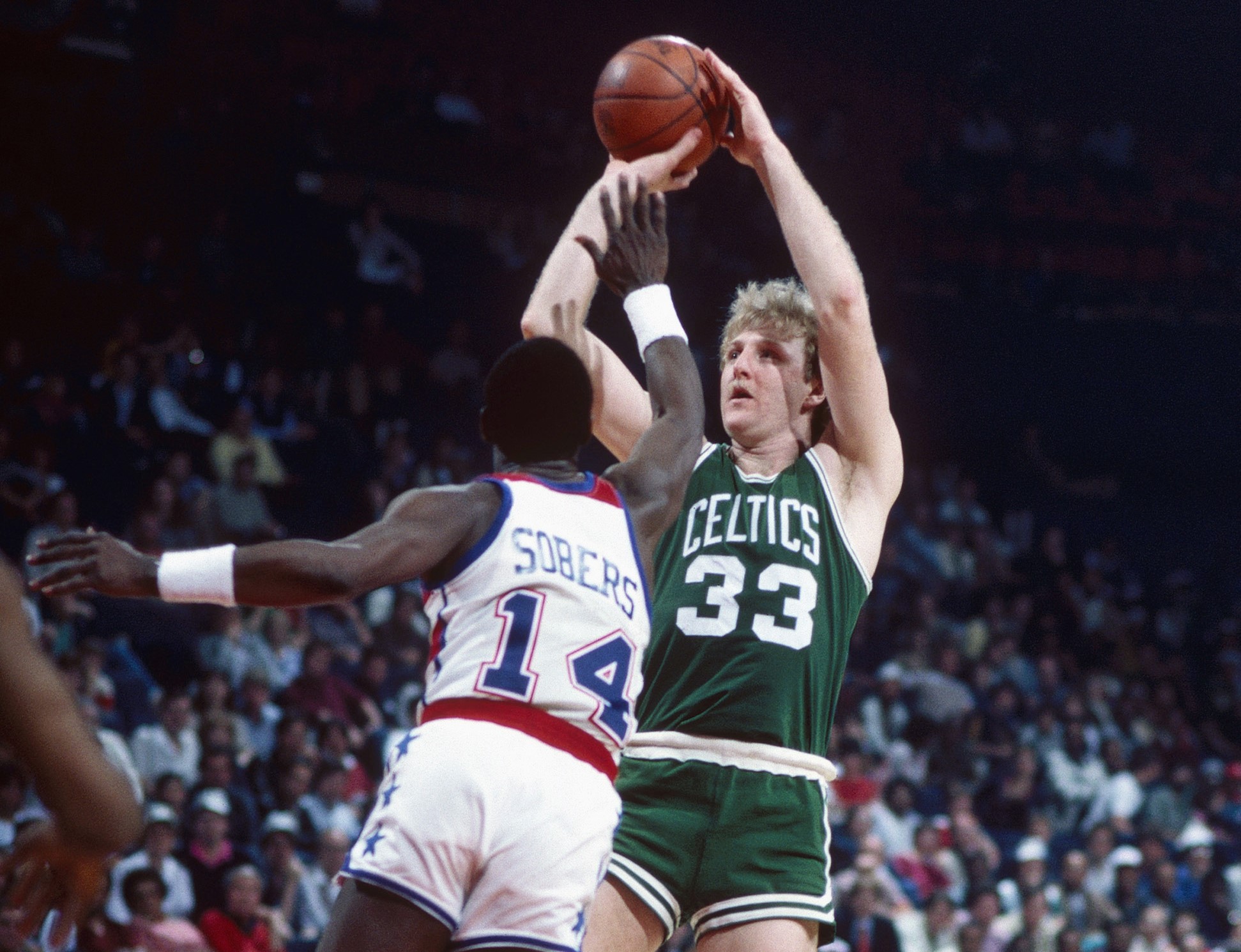 Boston Celtics forward Larry Bird makes a jump shot against Washington Bullets guard Ricky Sobers.
