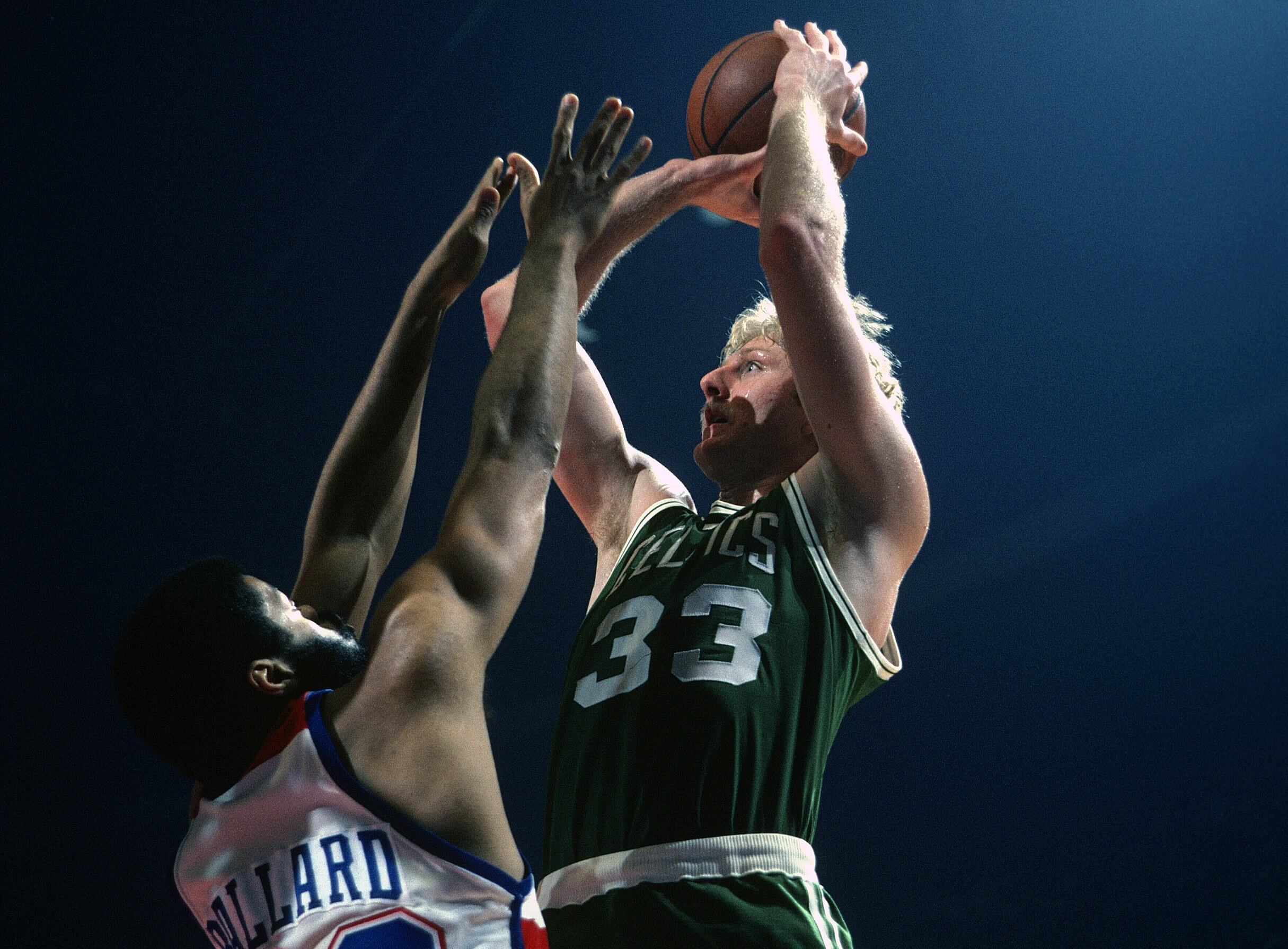 Larry Bird of the Boston Celtics shoots over Greg Ballard of the Washington Bullets.