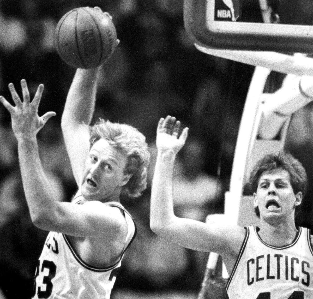 Boston Celtics' Larry Bird controls the ball over the Pistons' Joe Dumars with the Celtics' Danny Ainge