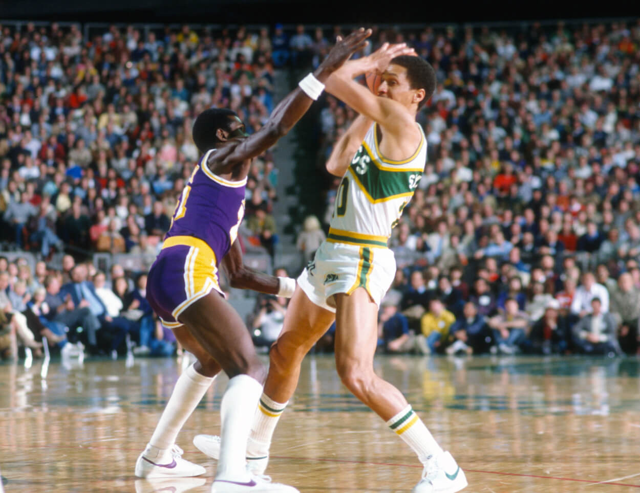 Michael Cooper of the Los Angeles Lakers puts the pressure on Phil Smith of the Seattle SuperSonics.