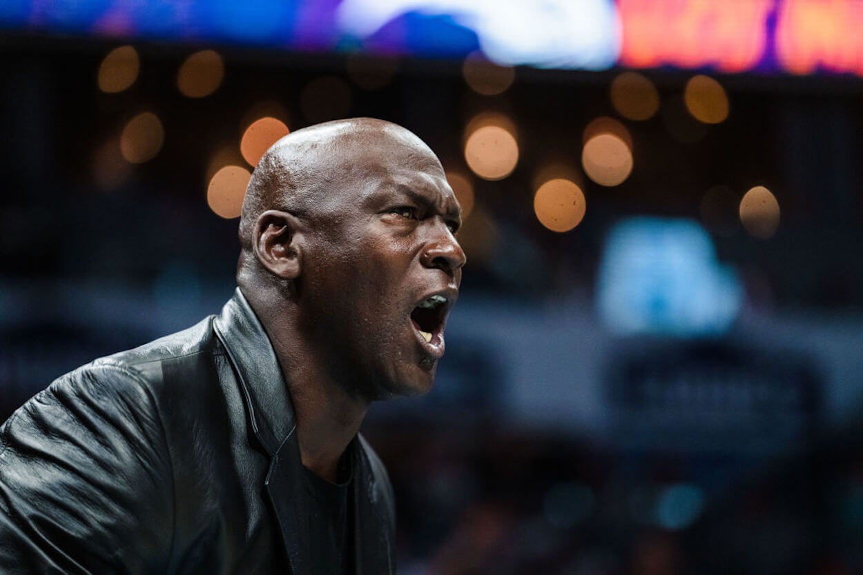 Michael Jordan reacts courtside during a Charlotte Hornets game.