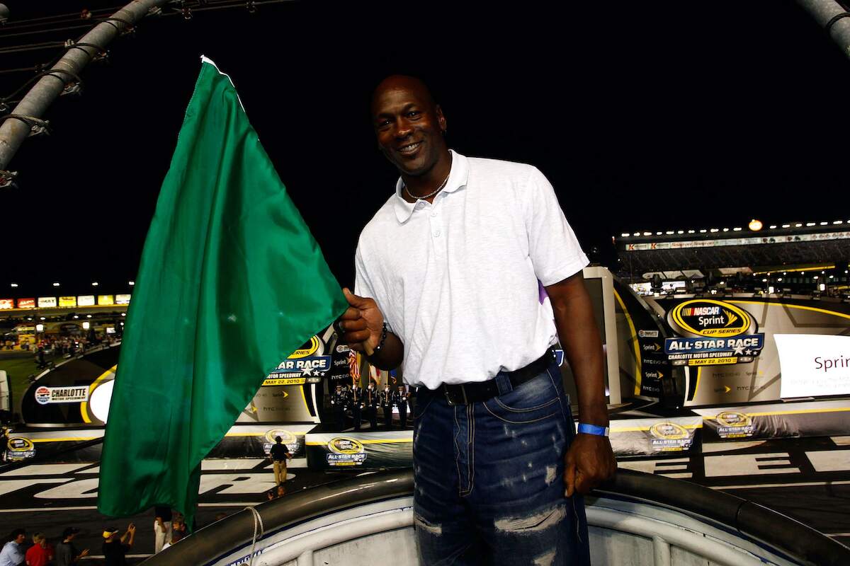 Michael Jordan holds a flag at a NASCAR media event