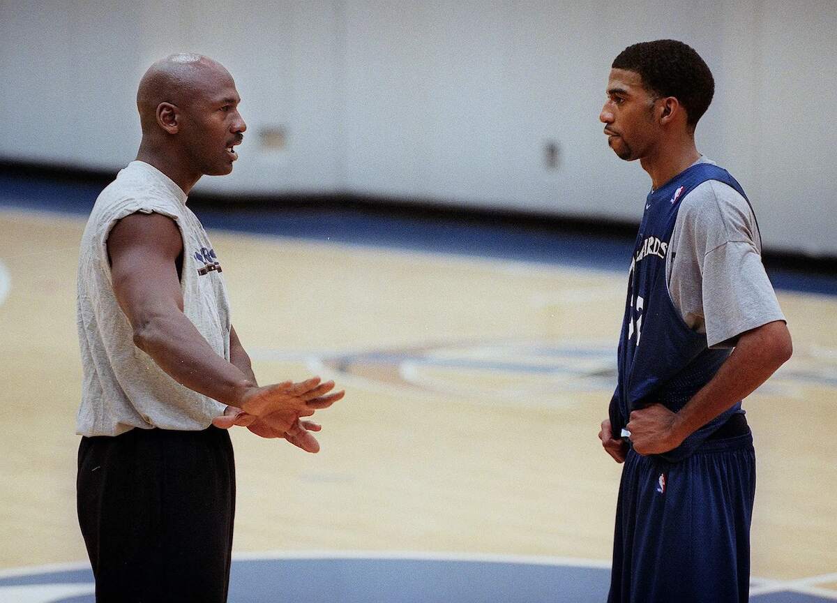 Michael Jordan gives instruction to Wizards player Richard Hamilton during a round of practice