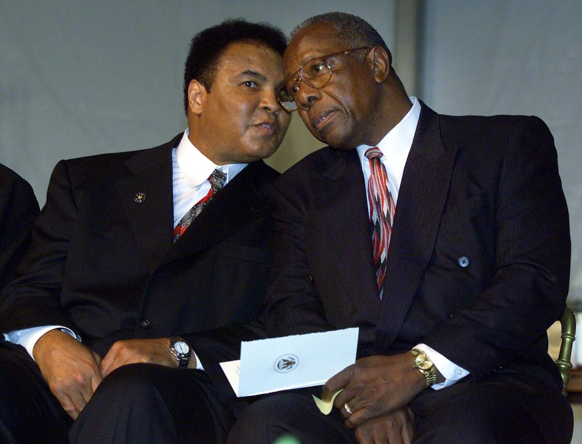 Legendary athletes Muhammad Ali talks with Hank Aaron during the Presidential Citizens Medal ceremony in 2001 at the White House