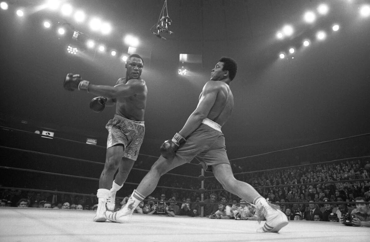Muhammad Ali steps away from a roundhouse left thrown by Joe Frazier during their 1971 title bout