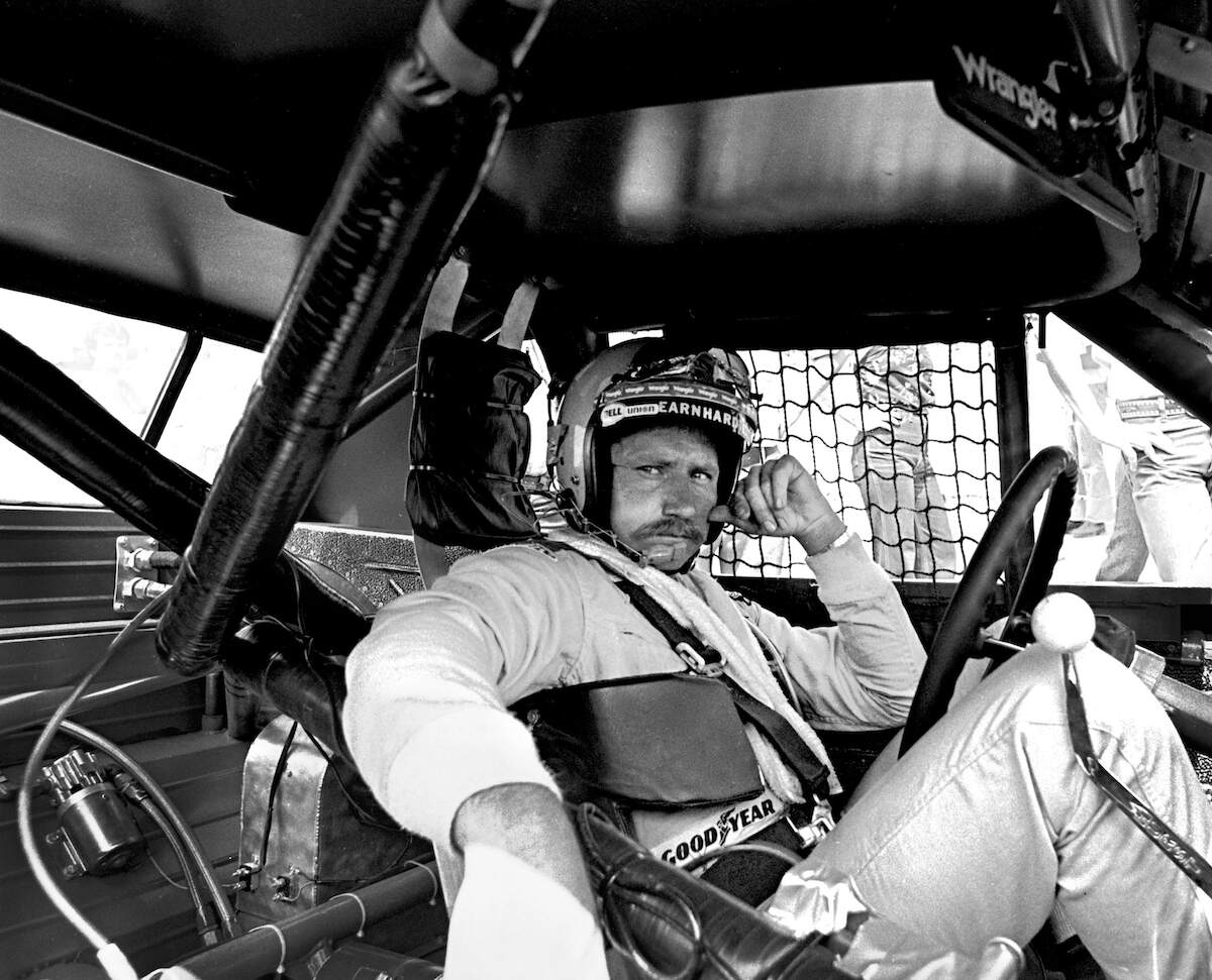 NASCAR's Dale Earnhardt Sr sits in his #2 Wrangler Pontiac Grand Prix while it's repaired after an accident during the 1981 Firecracker 400 at the Daytona