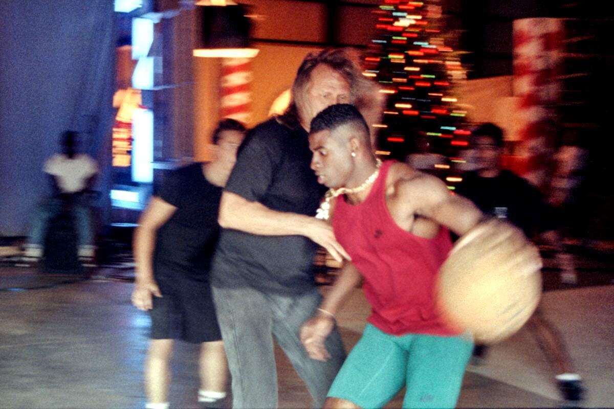 NFL and MLB player Deion Sanders plays basketball while on a break from filming a Nike commercial in 1992