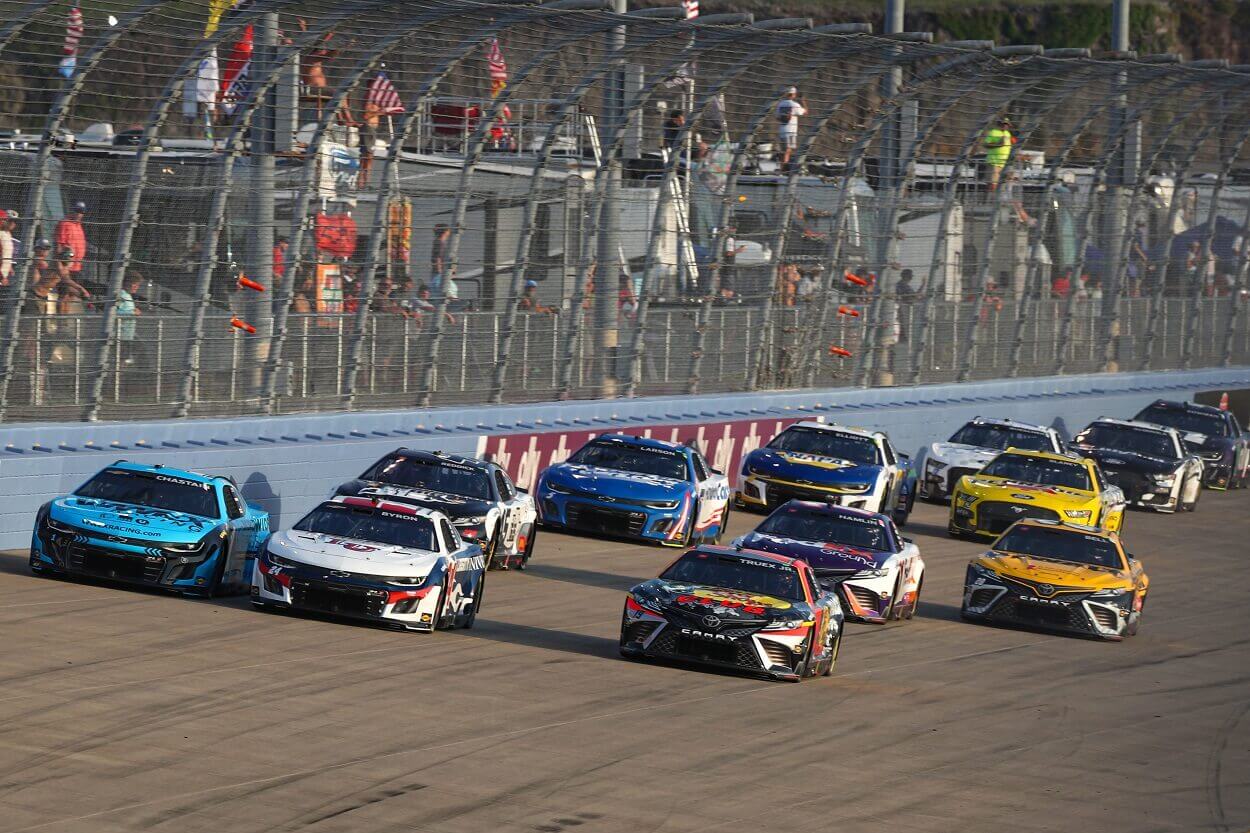 Ross Chastain, driver of the #1 Worldwide Express Chevrolet, William Byron, driver of the #24 Liberty University Chevrolet, and Martin Truex Jr., driver of the #19 Bass Pro Shops Toyota, lead the field during the NASCAR Cup Series Ally 400 at Nashville Superspeedway on June 25, 2023 in Lebanon, Tennessee