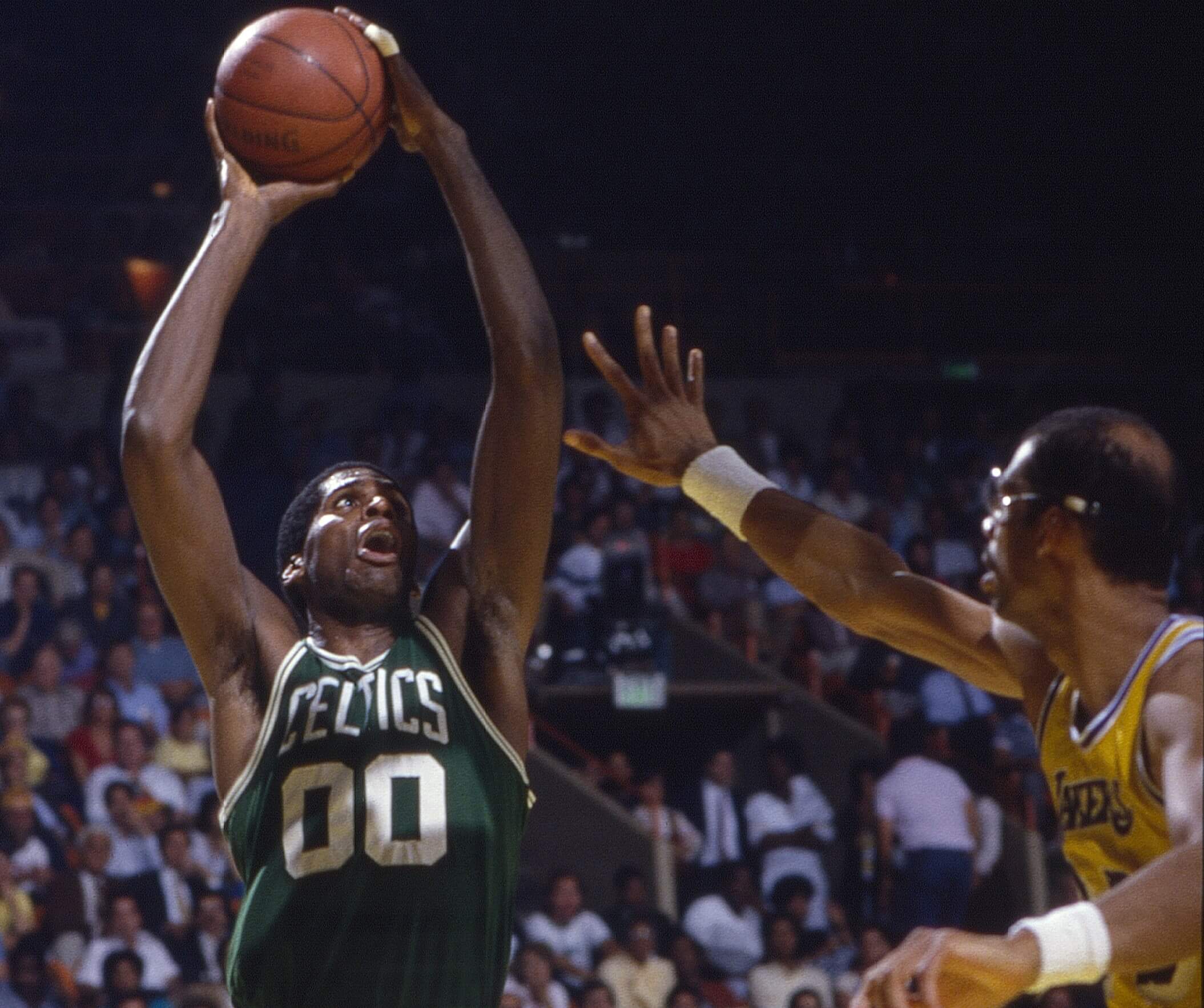 Boston Celtics Robert Parish takes a shot over Los Angeles Lakers Kareem Abdul-Jabbar.