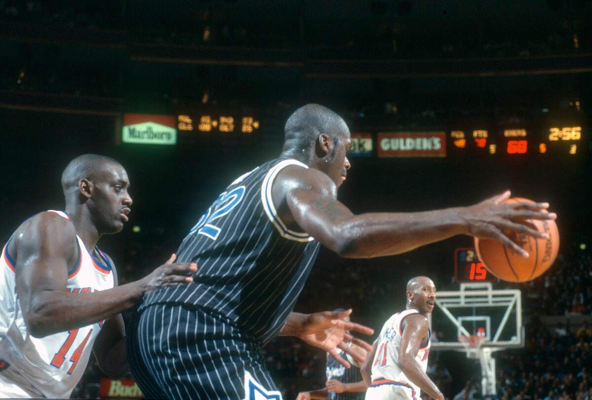 Shaquille O'Neal of the Orlando Magic backs in on Anthony Mason of the New York Knicks in 1994