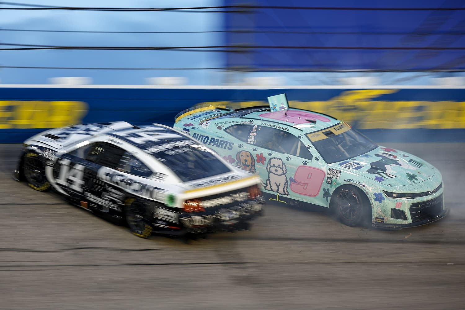 Chase Elliott, driver of the No. 9 Chevrolet, and Chase Briscoe, driver of the No. 14 Ford, spin during the NASCAR Cup Series Cook Out Southern 500 at Darlington Raceway on Sept. 4, 2022.