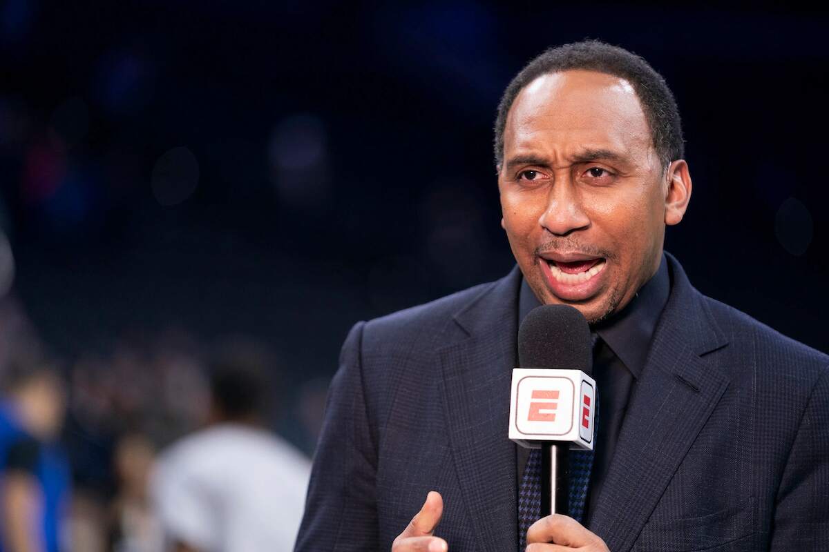 ESPN's Stephen A. Smith covers a sporting event while talking into his microphone
