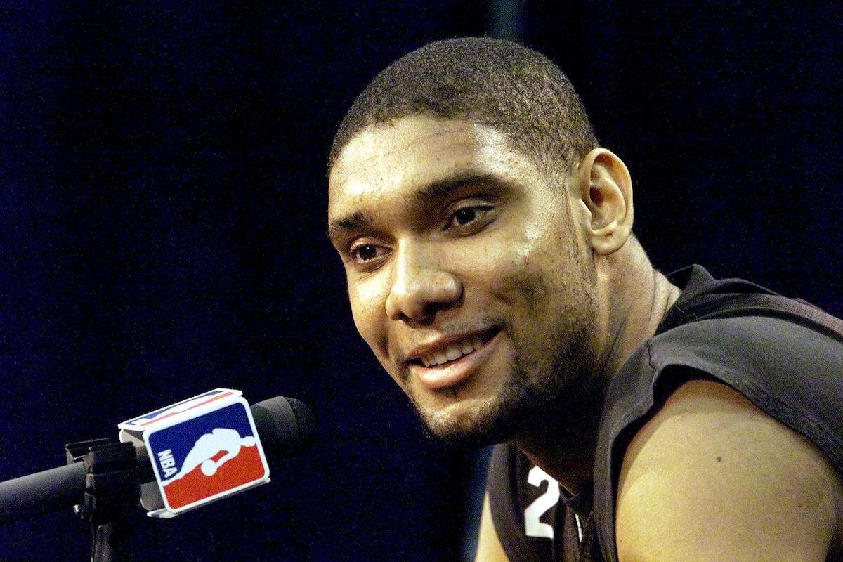 Tim Duncan of the San Antonio Spurs answers questions after his team's workout in 1999