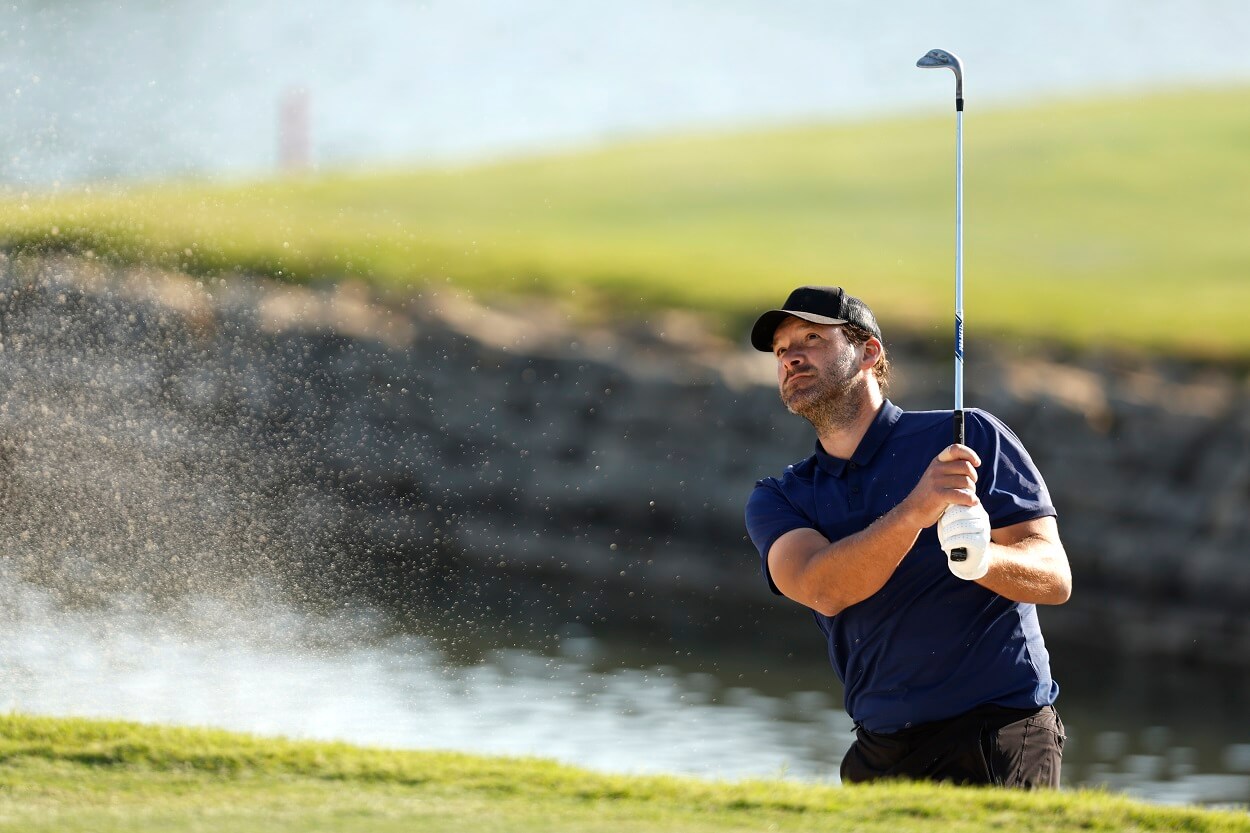 Former NFL player Tony Romo hits a shot out of a sand trap on the 18th hole during the Invited Celebrity Classic at Las Colinas Country Club on April 23, 2023