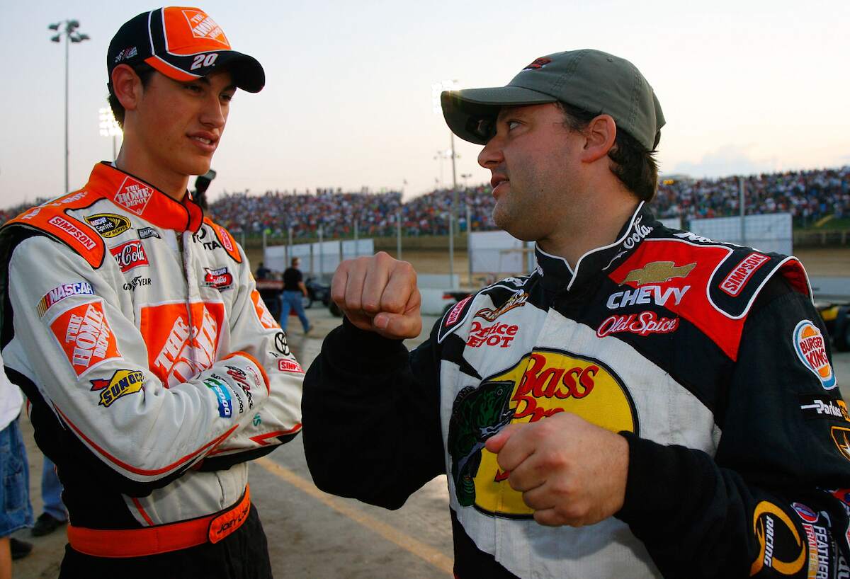 Joey Logano, driver of the #20 Home Depot car speaks with Tony Stewart, driver of the #14 Bass Pro Shops Chevrolet in 2009
