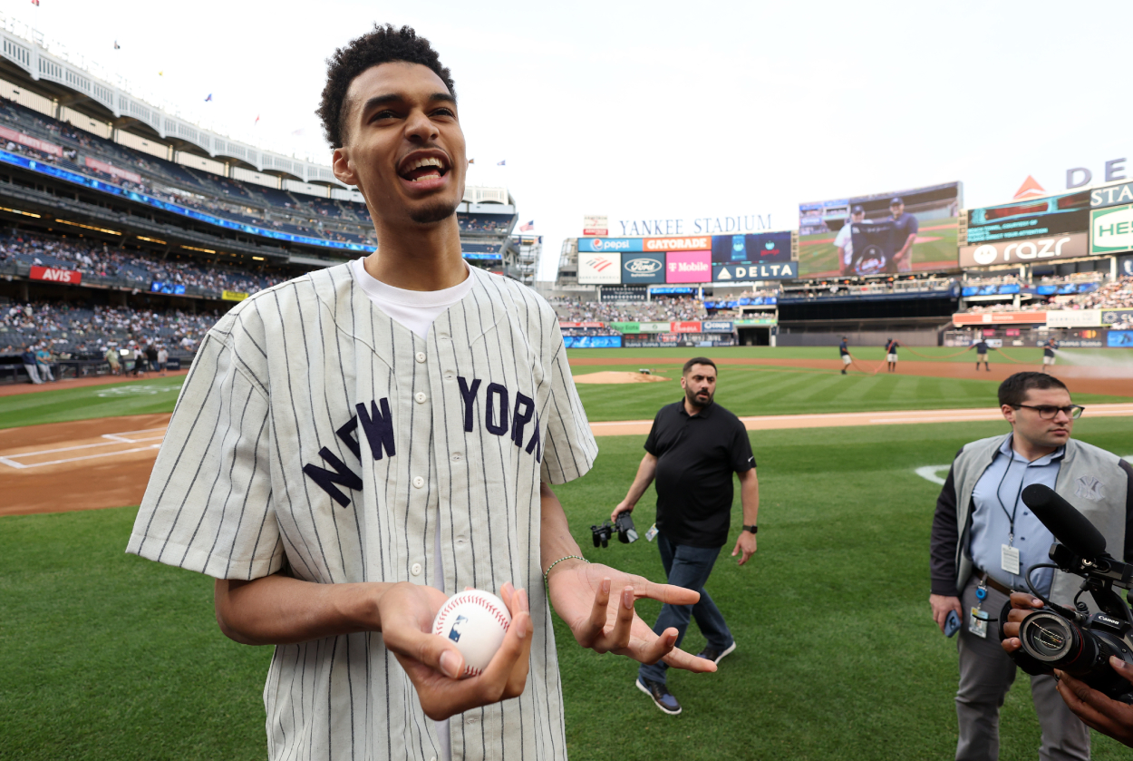 Victor Wembanyama, projected first round pick in the 2023 NBA Draft, prepares to throw out the ceremonial first pitch prior to the game between the Seattle Mariners and the New York Yankees.