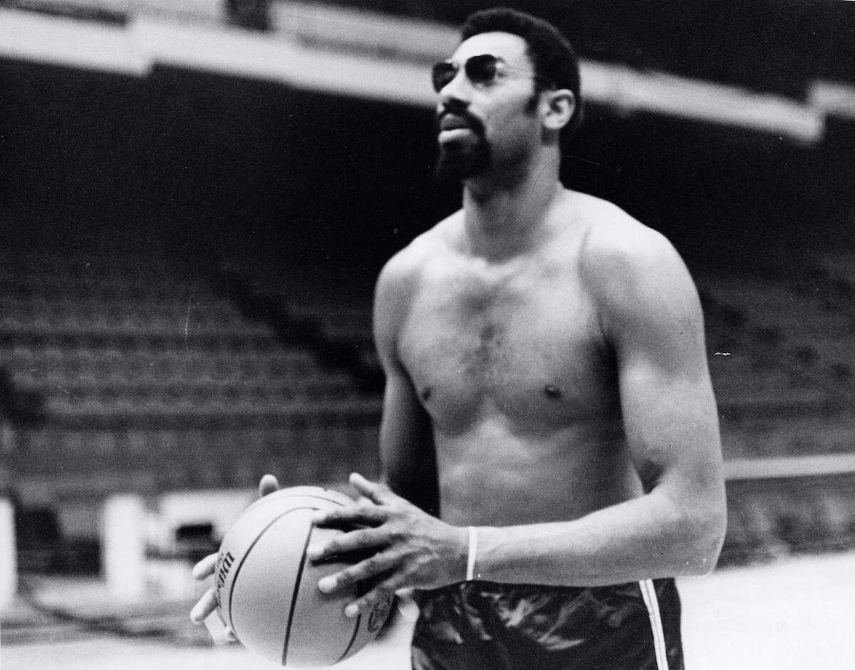 NBA player Wilt Chamberlain practices shirtless